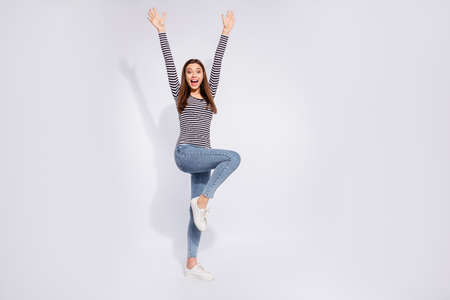 Full length body size view of her she nice attractive charming cheerful cheery overjoyed straight-haired girl rising hands up having fun best news isolated over white light backgroundの写真素材
