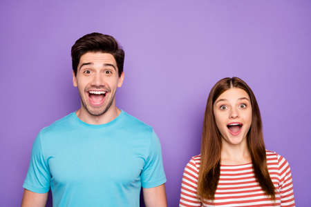 Closeup photo of two funny people couple positive emotions good mood open mouth listen unbelievable news wear stylish casual outfit clothes isolated purple color backgroundの写真素材
