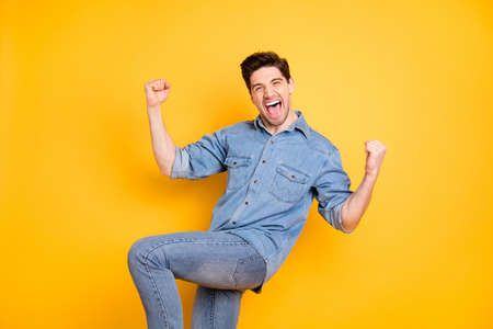 Turned photo of crazy ecstatic excited overjoyed man screaming shouting jumping making fists...