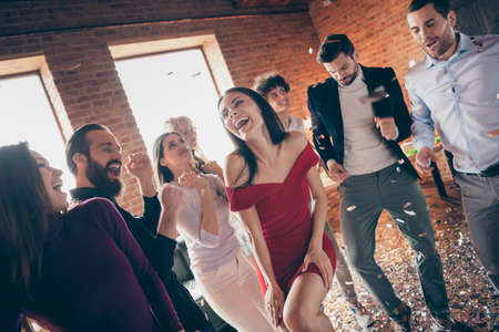 Photo of eight friends dance floor spending x-mas students party together little drunk alcohol bar crazy dancing wear formalwear red dress shirts restaurant indoorsの写真素材