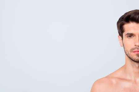 Cropped closeup photo of macho guy hide half face perfect neat beard looking indifferent relaxed mind torso masculine body metrosexual isolated grey backgroundの写真素材