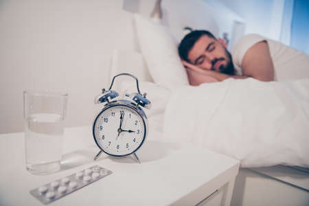 Portrait of his he nice attractive sleepy calm guy lying on bed sleeping disease therapy treatment...