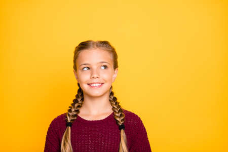 Close-up portrait of her she nice attractive charming lovely cute cheerful cheery pre-teen girl creating new idea isolated over bright vivid shine vibrant yellow color backgroundの写真素材