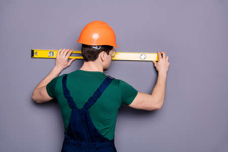 Rear behind view photo of handsome masculine worker guy skilled engineer, measure rack length of...