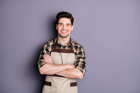 Photo of handsome brunet guy arms crossed friendly smiling positive good mood professional worker wear apron plaid shirt isolated grey color backgroundの写真素材