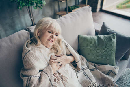 Photo of white haired aged granny in despair holding chest zone cardiac difficulties afraid heart...
