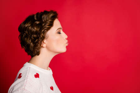 Profile side photo of positive peaceful girl have 14-february date kiss her boyfriend wear stylish trendy isolated over bright color backgroundの写真素材