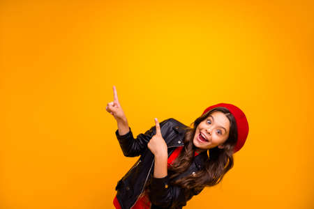 Portrait of her she nice attractive lovely excited glad cheerful cheery long-haired girl pointing up recommend decision advert isolated over bright vivid shine vibrant yellow color backgroundの写真素材