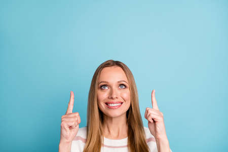 Photo of positive cheerful cute pretty nice woman smile toothy pointing up at sales started isolated...