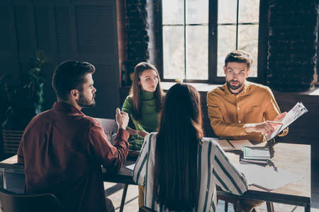 Skilled smart businesspeople ceo boss chief director company owner wearing casual formal-wear attending conference discussing IT progress at modern industrial loft style interior work place stationの写真素材
