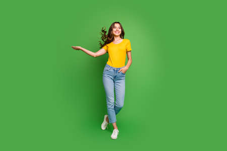 Full length body size view of nice attractive lovely slim fit thin dreamy, cheerful cheery wavy-haired girl having fun throwing hair isolated on bright vivid shine vibrant green color backgroundの写真素材