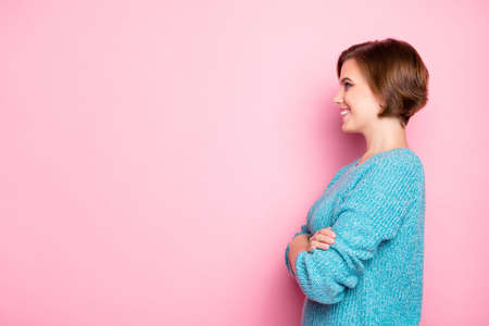 Side profile photo of satisfied confident lady in blue clothes standing with arms folded isolated pink copy space backgroundの写真素材