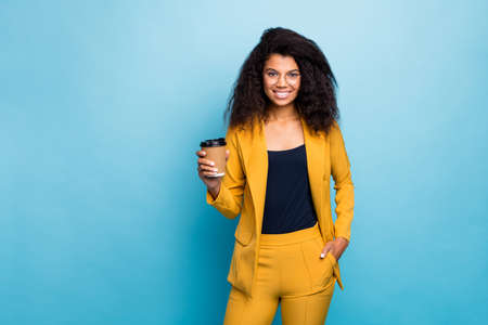 Photo of attractive chic dark skin wavy business lady holding hot takeout coffee beverage corporate...
