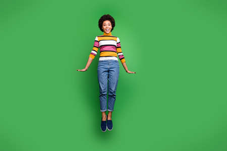 Full size photo of cheerful funky afro american girl jump enjoy fall weekends wear stylish trendy...