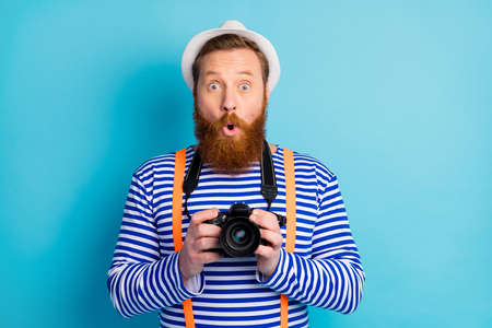 Portrait of astonished man traveler have tourism voyage want shooting impressed by good look wear...