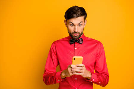 Photo of attractive business guy hold telephone social network, worker reading good news growth blog...