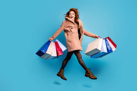 Omg off sales. Full length photo of surprised shocked woman jump buy bargains hold shopping bags...