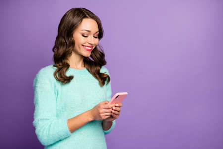 Photo of funny pretty lady hold telephone hands writing new creative post blog influencer wear...