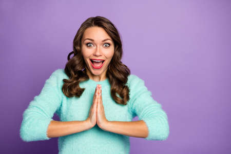 Come on. Photo of beautiful crazy curly lady holding hands together begging join her black friday shopping wear casual teal fluffy pullover isolated purple pastel color backgroundの写真素材