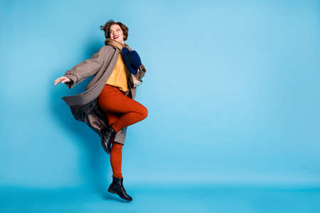 Full body profile photo of carefree lady jump up high hold stylish retro cap good mood nice day wear...