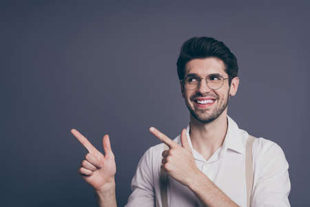 Photo of attractive successful business man leader indicating fingers empty space good news dressed...