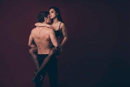 Rear view photo of two horny people handsome topless husband hold hands raise nude hot black boudoir...