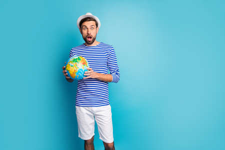 Photo of crazy funky guy open mouth hold big world globe map, traveler see cheap tours abroad wear...