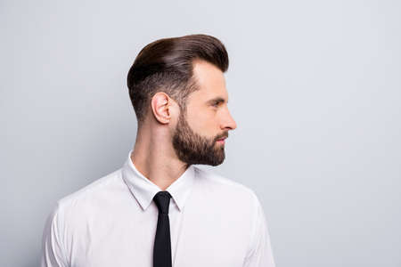 Closeup profile photo of attractive handsome business man looking empty space showing perfect neat beard wear white office shirt tie isolated grey color backgroundの写真素材