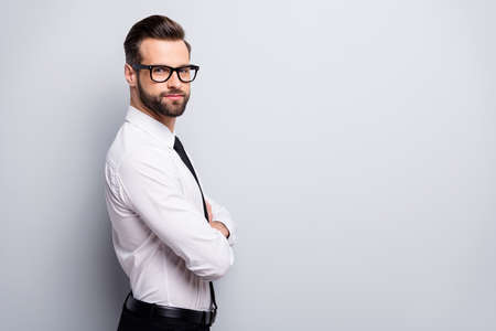 Profile photo of young handsome serious business man bossy crossed arms employer investor wear specs...