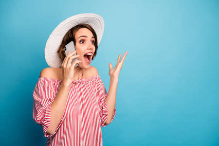 Portrait of her she nice attractive lovely charming pretty cute amazed cheerful cheery girl calling friend sharing news isolated over bright vivid shine vibrant blue color backgroundの写真素材