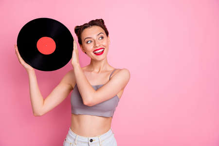 Portrait of lovely cute girl music lover hold vinyl plate gramophone disc want have retro party wear...