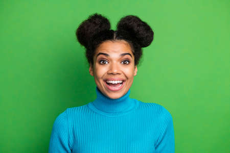 Closeup photo of funny beautiful pretty dark skin lady excited good mood beaming smile crazy facial expression wear blue turtleneck sweater isolated green color backgroundの写真素材