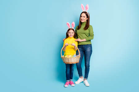 Full length body size view of nice attractive lovely cheerful cheery girls carrying festive...