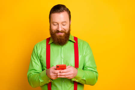 Portrait of positive cheerful irish blogger person use smartphone read social media news repost...
