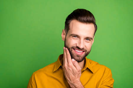 Close-up portrait of his he nice attractive cheerful cheery glad bearded guy touching fresh stubble...