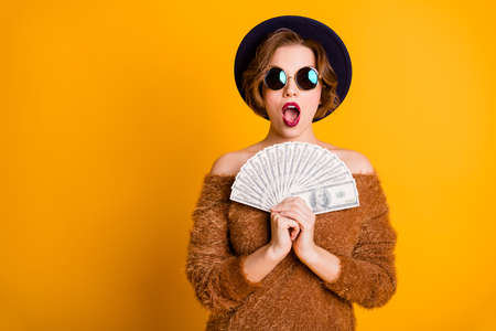 Photo of amazed lady open mouth hold fan bucks first savings salary income jackpot excited crazy...