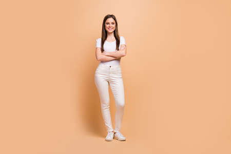 Full size photo of charming attractive girl cross hands enjoy spring free time working day rest relax wear good look outfit shoes isolated over beige color backgroundの写真素材