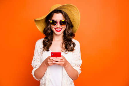 Photo of funny lady summer time holding telephone sending best friend photos from tropical ocean...