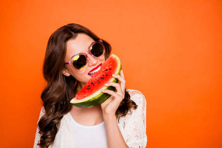 Photo of casual curly wavy cute nice charming pretty millennial teenager biting watemelon with white...