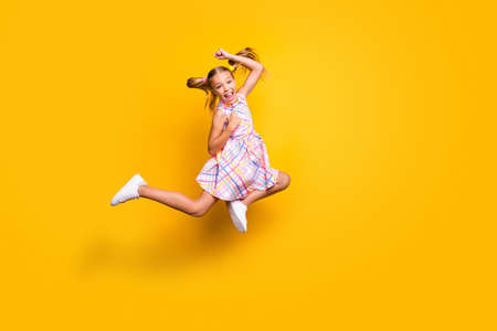Full body photo cheerful crazy funky kid jump celebrate discount lottery victory raise fists scream...