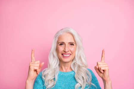 Close up photo of positive cheerful old woman point index finger up copyspace present adverts...