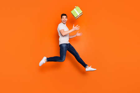 Full length profile photo of crazy guy jump high up catch big green giftbox unexpected present wear...