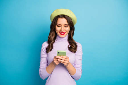 Photo of funny charming lady holding telephone hands writing message best friends traveling wear...