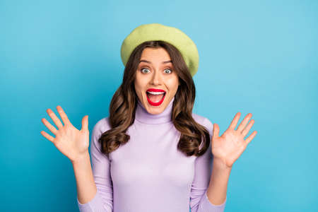 Photo of funky traveler lady toothy beaming smiling open mouth excited feelings wear green beret hat purple turtleneck isolated bright blue color backgroundの写真素材