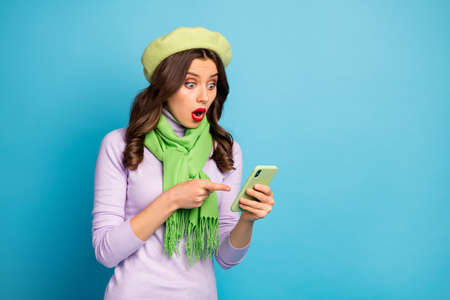 Photo of amazed crazy lady hold telephone read new post comments directing finger device screen wear...