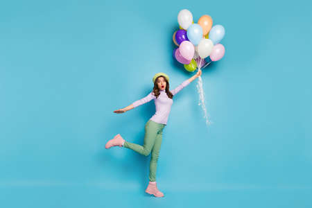 Full length photo of crazy pretty lady hold many air balloons shocked raising up with wind wear...