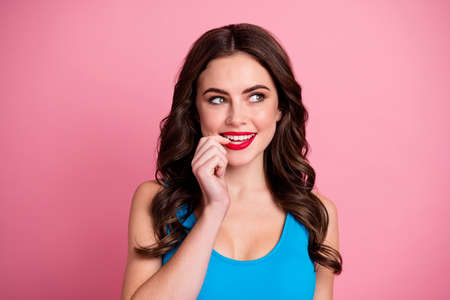 Closeup photo of attractive lady good mood look side empty space bite finger nail have tricky sly...