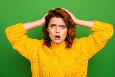 I cant do that. Frustrated shocked nervous woman hear unbelievable news her work mistake puzzled touch hands head scream wear good look knitted sweater isolated green color backgroundの写真素材