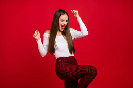 Portrait of delighted positive rejoice lady celebrate beauty chic lottery win raise fists scream yeah wear good look clothes isolated over shine color backgroundの写真素材