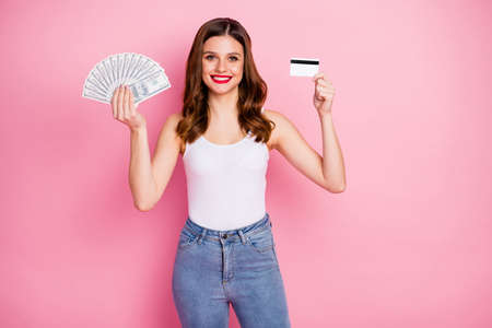Portrait of positive cheerful girl hold money fan deposit debit card recommend use bank cashback...